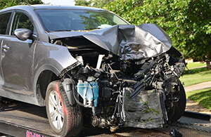 A vehicle with major front end damage from a car accident